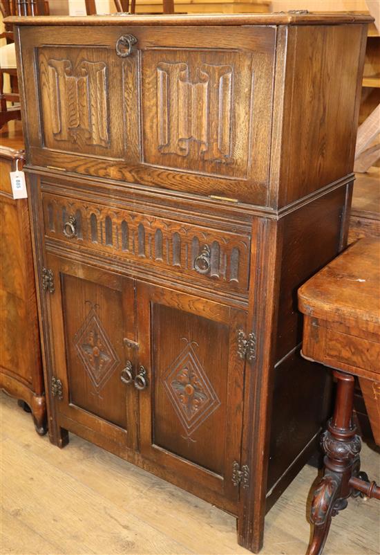 An oak linenfold moulded cocktail cabinet W.74cm